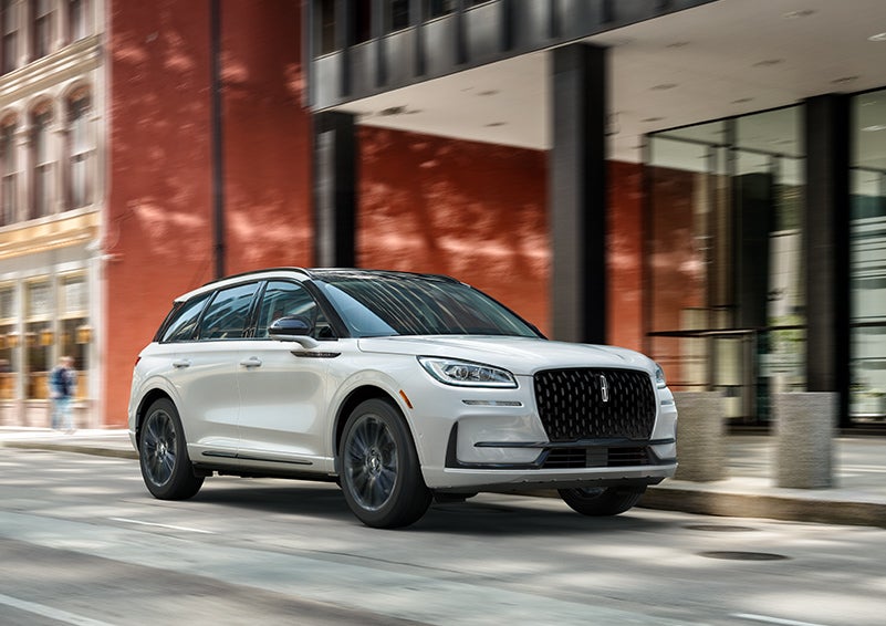 The 2024 Lincoln Corsair® SUV with the Jet Appearance Package and a Pristine White exterior is parked on a city street. | Caruso Lincoln in Long Beach CA