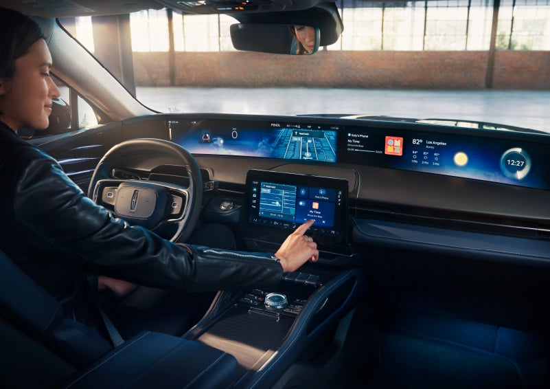 The driver of a 2024 Lincoln Nautilus® SUV interacts with the center touchscreen. | Caruso Lincoln in Long Beach CA